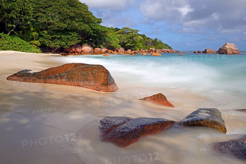 Beach and rocks of Anse Lazio in the evening