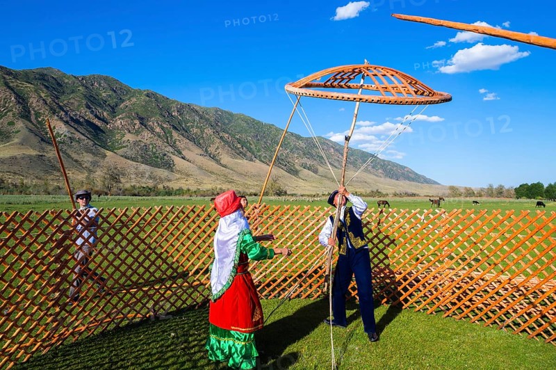 Kazakh men building a yurt