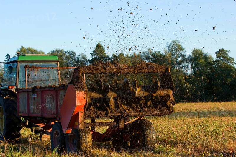 John Deere tractor pulling manure spreader