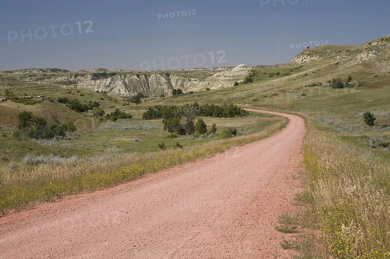 View of red scoria road in ranch country