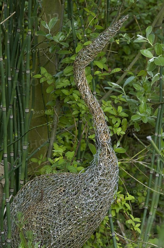 Ornamental wire mesh heron in garden