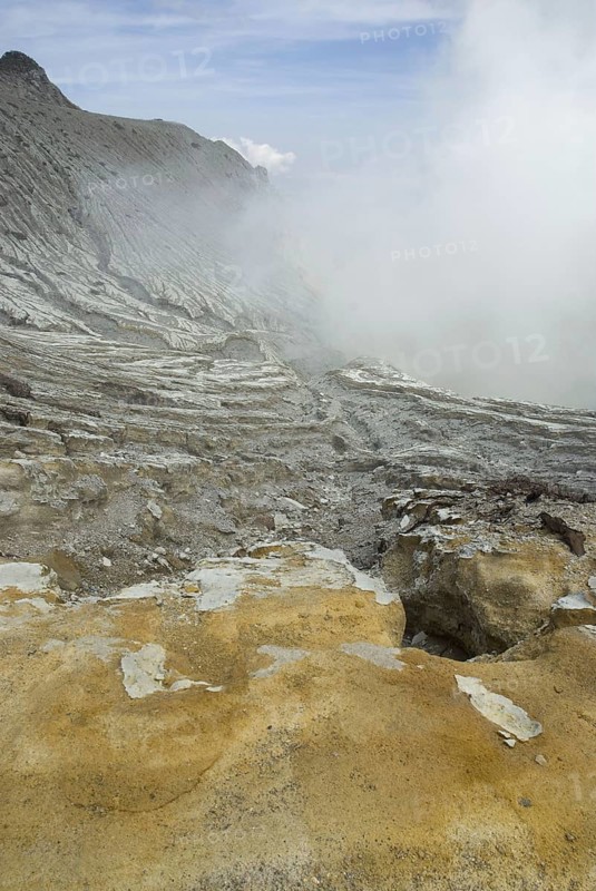 Slopes of a volcanic crater with rising steam