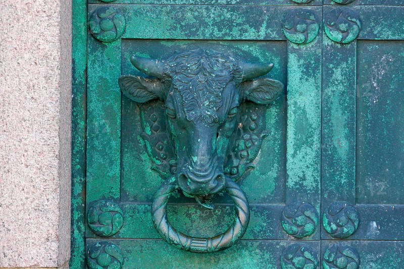 Bull's head detail of a bronze cathedral door in the historic town