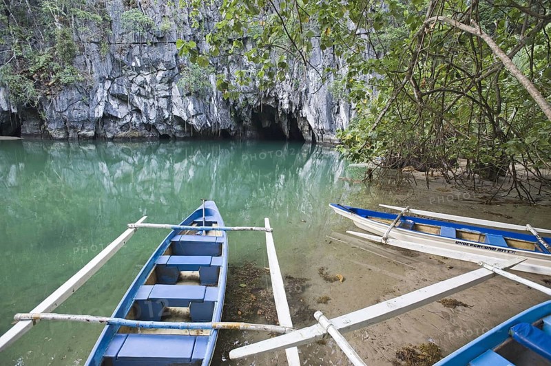 Tourist boats in front of the cave entrance of the Subterranean River
