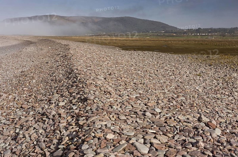 View of shingle bank spreading inland as sea levels rise