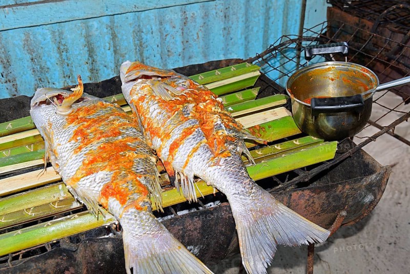 Creole-style snapper marinated on a charcoal grill