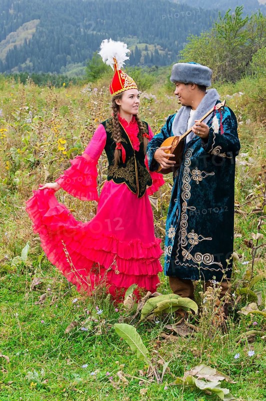 Kazakh man singing and playing dombra for a woman