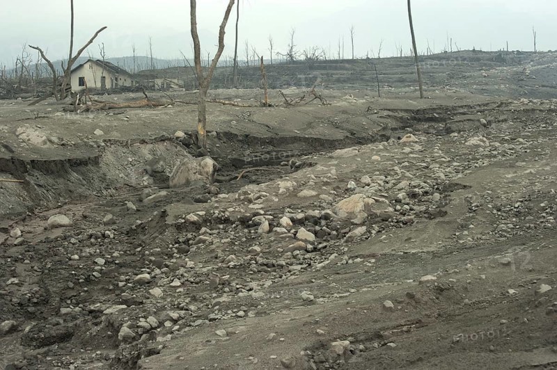 Riverbed and field covered with ash