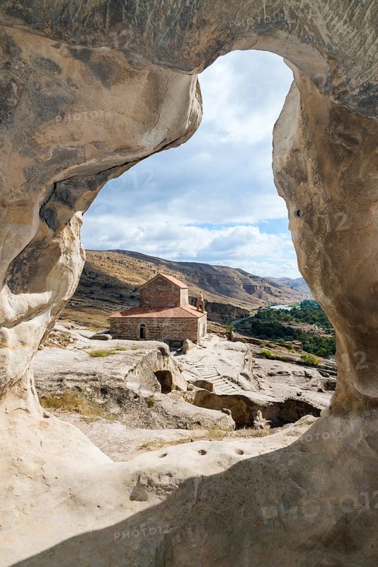 Christian princely basilica from the 10th century with view through a rock arch