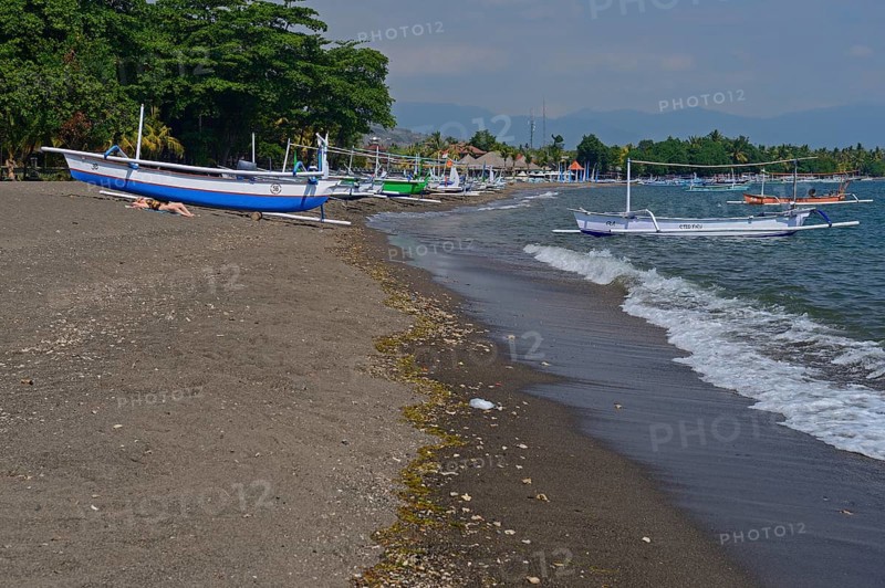 Traditional outrigger boats on the black lava beach