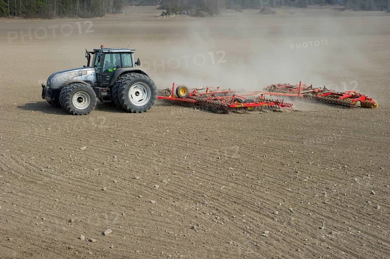 Valtra tractor with Vaderstad NZA-800 and Vaderstad RS-820 harrows and rollers working farmland