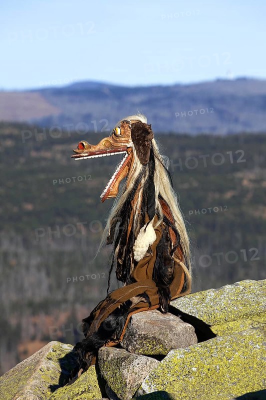 Creepy wooden devil figure on the summit of the Lusen in autumn