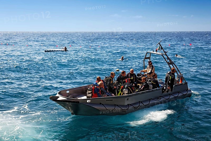Divers sitting in aluminuim boat