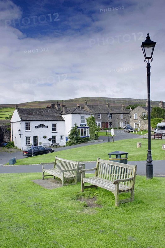 Village green with benches and lamppost