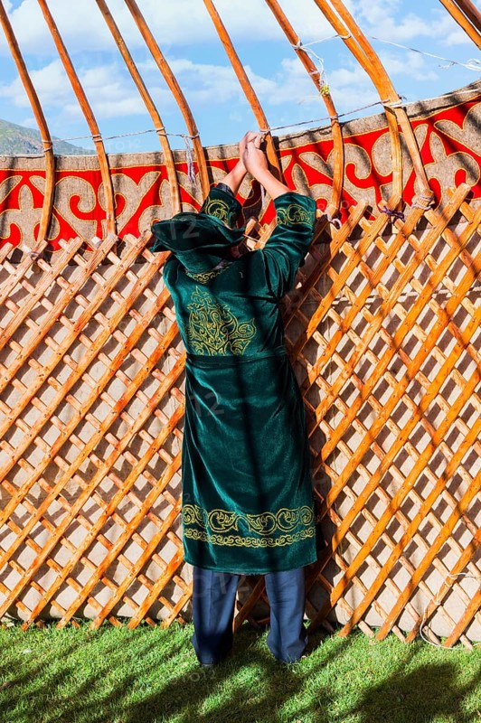 Kazakh men building a yurt