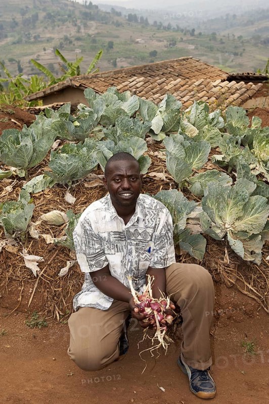 Farmer with produce grown in the keyhole vegetable garden