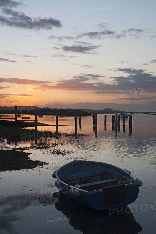 View of boats in coastal stream at high tide