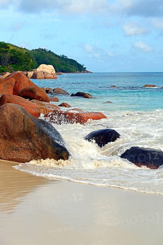 Beach and rocks of Anse Lazio in the evening