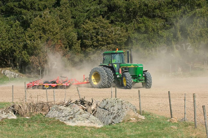 John Deere 4455 tractor pulling Vaderstad cultivator
