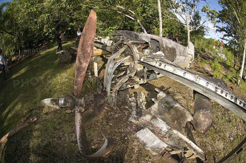 Propeller and bomb on the wing of a wrecked World War II aircraft