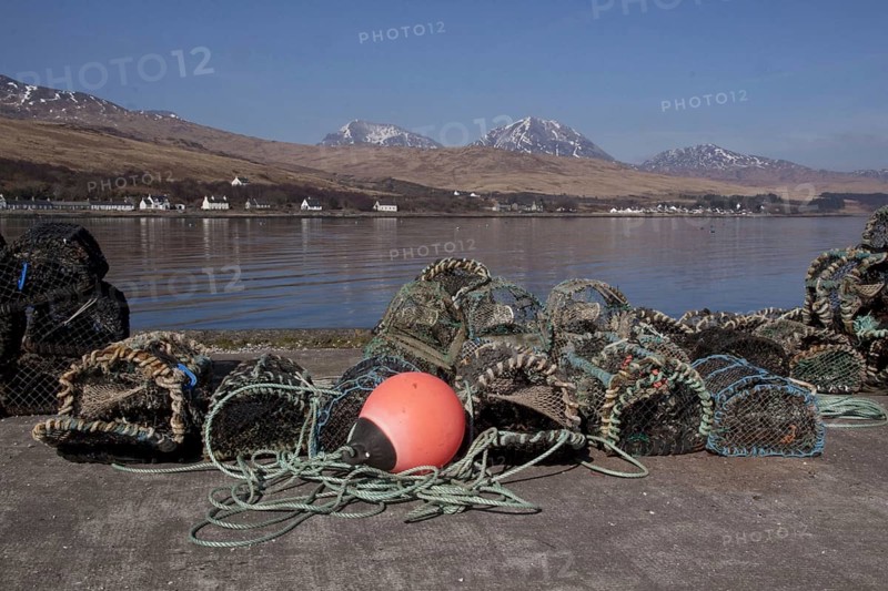 Lobster pots and floats on the pier at Craighouse with the porridge from the Jurassic behind them