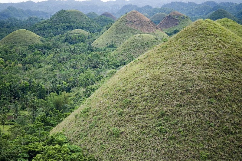 Cone-shaped karst hills of grass-covered limestone