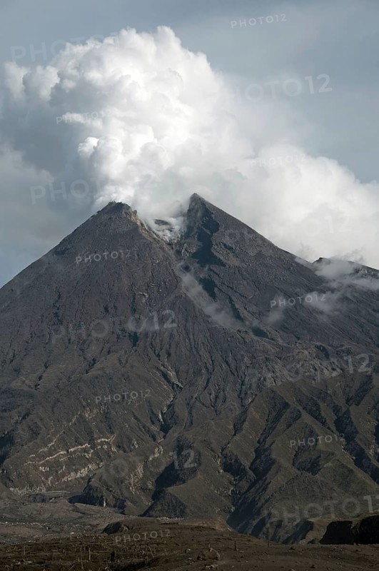 Recently erupted volcano with ash clouds