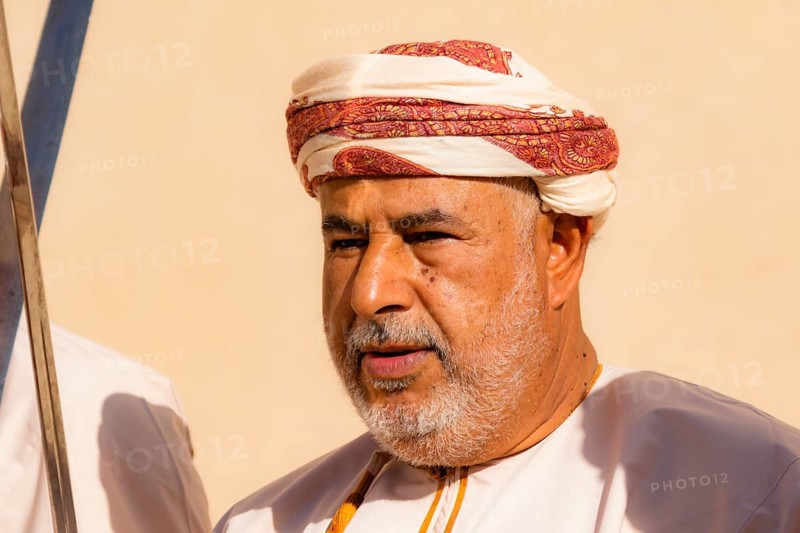 Man performing traditional songs during the Friday Goat Market in Nizwa