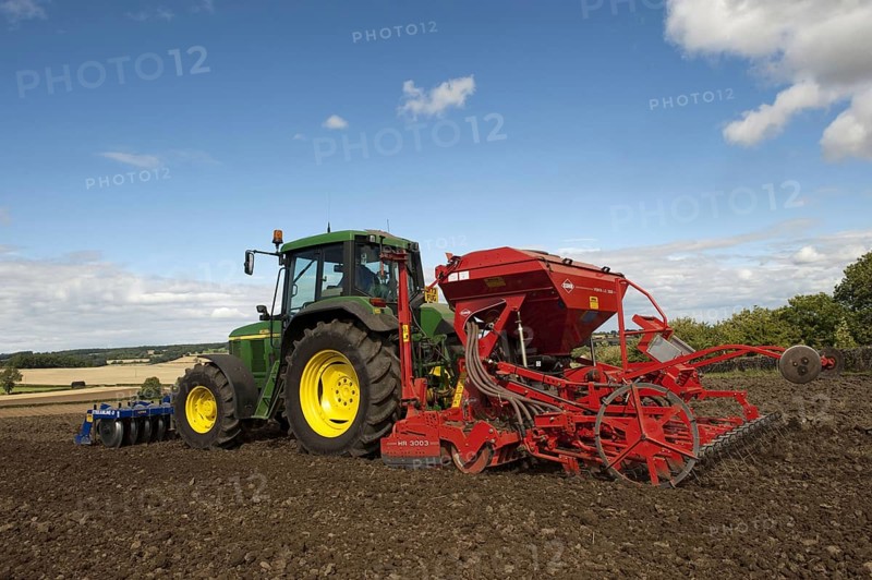 John Deere tractor with front press and rear seed drill