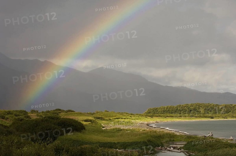 View of rainbow over coastal habitat
