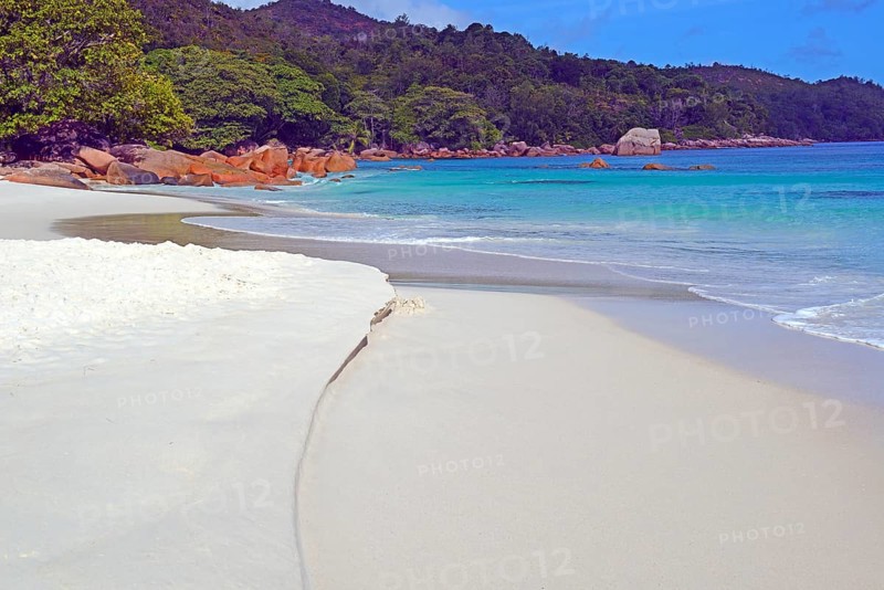 Beach and rocks of Anse Lazio in the evening