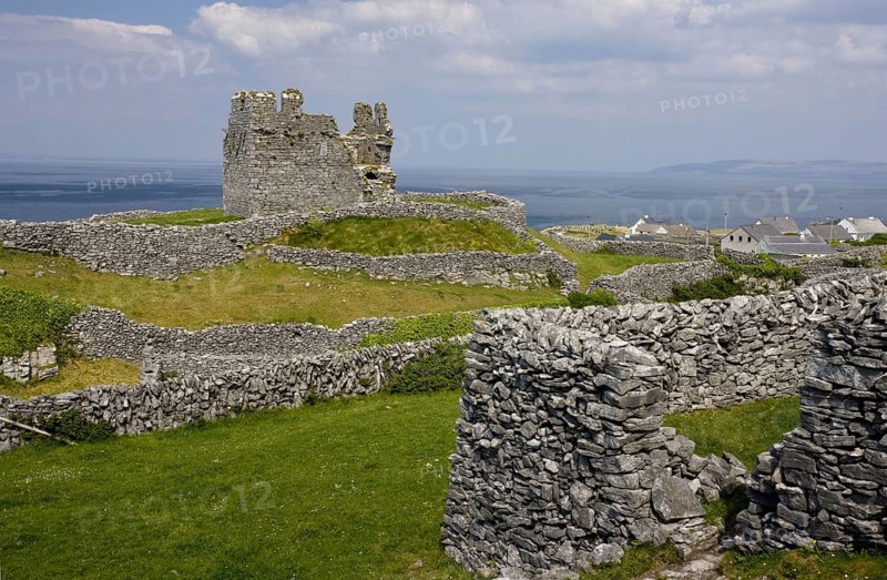 Ruins of a medieval castle between dry stone walls
