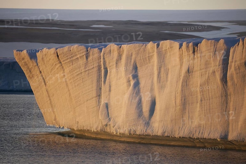 View of the end of the coastal glacier at sunset