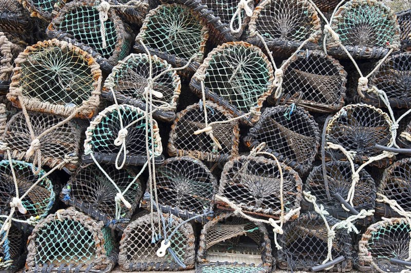 Lobster pots on quayside of harbour