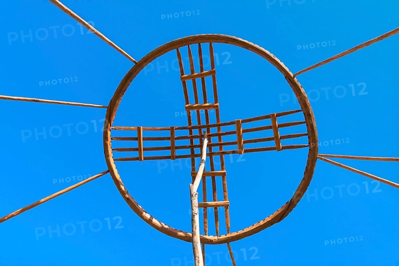 Kazakh men erecting the roof of a yurt