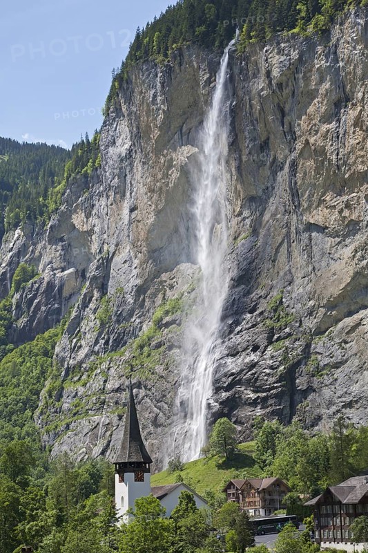 Waterfall flowing over mountain cliff