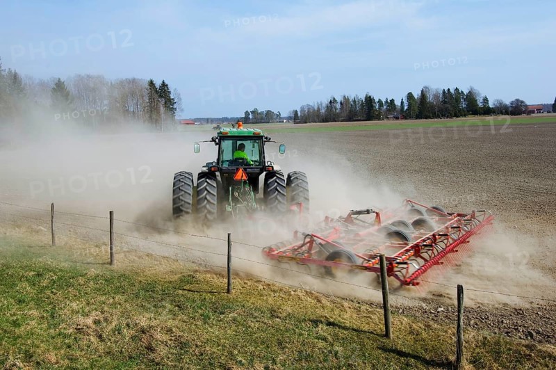 John Deere tractor pulling Vaderstad cultivator