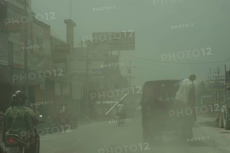Road with vehicles in ash cloud