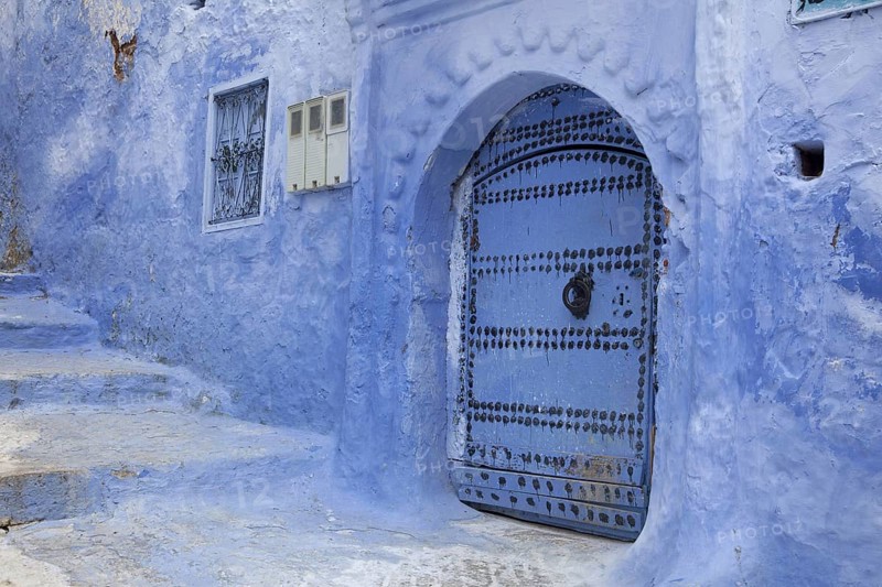 Blue door and stairs in an alley of the city
