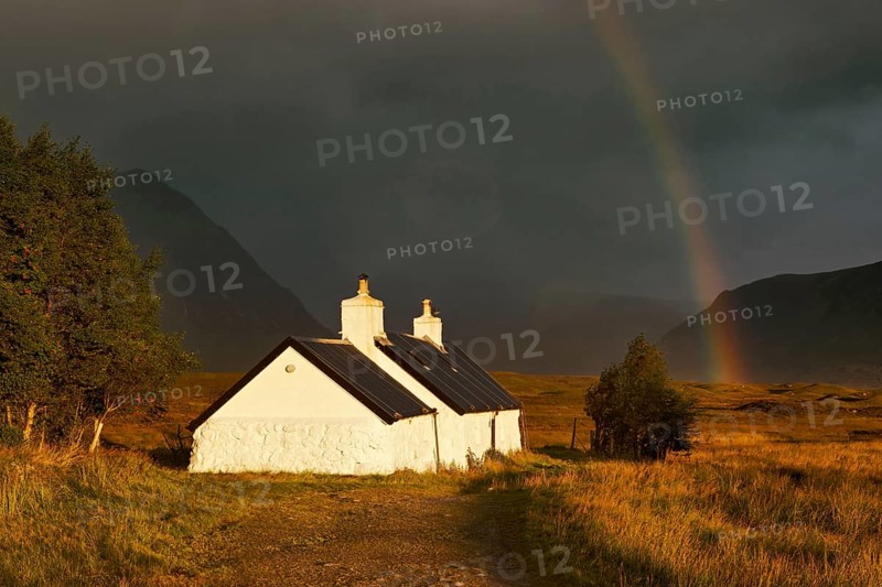 Blackrock hut at dawn with rainbow and gathering storm