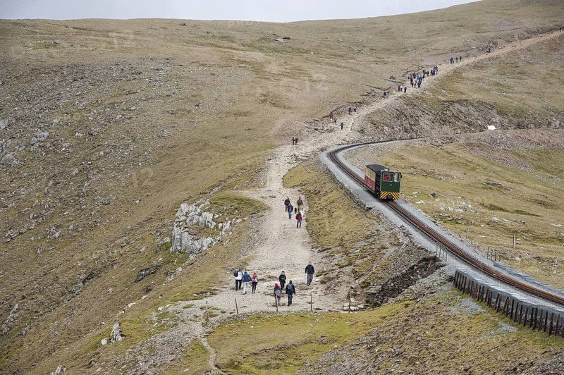 Hiker and train in the mountains