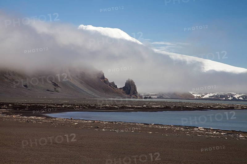 Black sandy beach and snow-covered volcano Beerenberg
