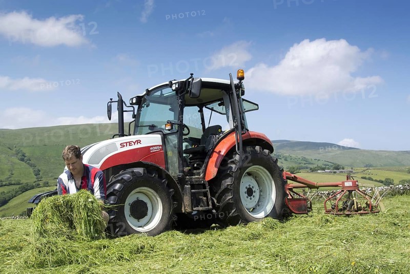 Farmer checks the quality of the mown grass