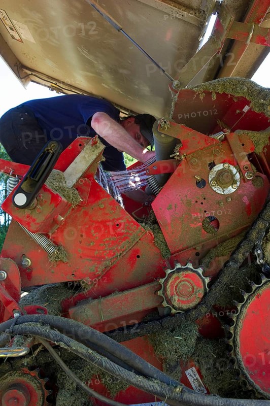 Farmer working on round baler