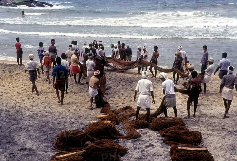 Fishermen hauling the fishing nets in Kovalam beach near Thiruvananthapuram