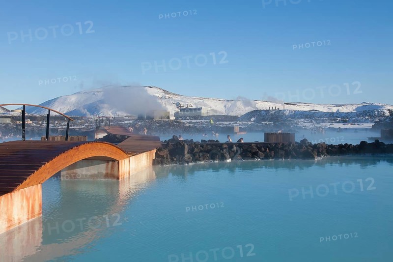 Tourists bathing in the blue lagoon rich in minerals such as silica and sulphur in a lava field in winter