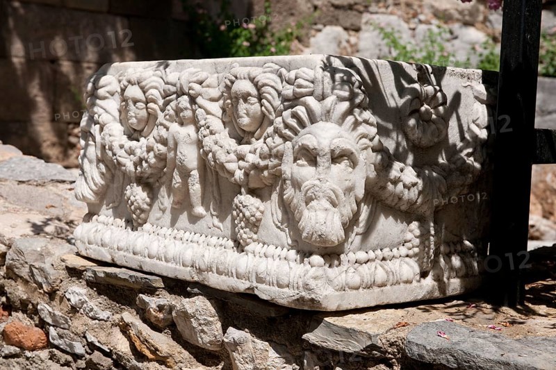 Weathered sarcophagus with relief heads