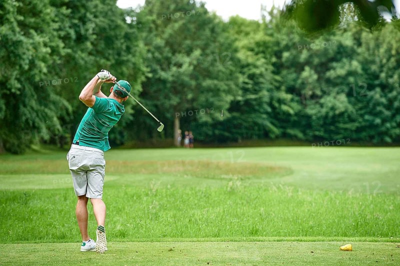 Golfer teeing off a ball
