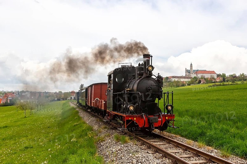 Steam train of the Haertsfeld Museumsbahn Schaettere railway steam train with Neresheim monastery