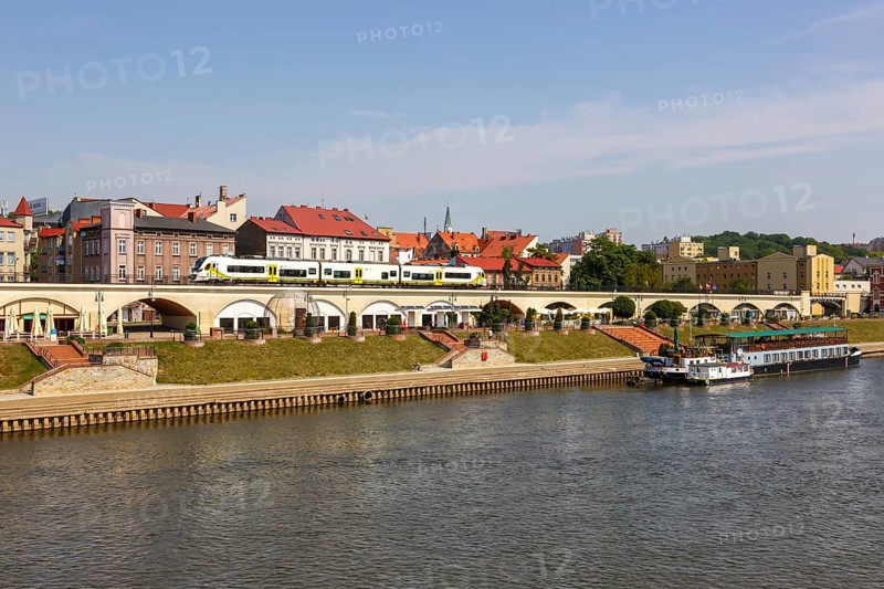 Landsberg an der Warthe town on the river with a Newag Impuls 2 regional train in Gorzow Wielkopolski